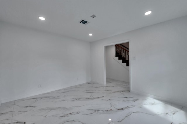 unfurnished room with baseboards, recessed lighting, and stairs