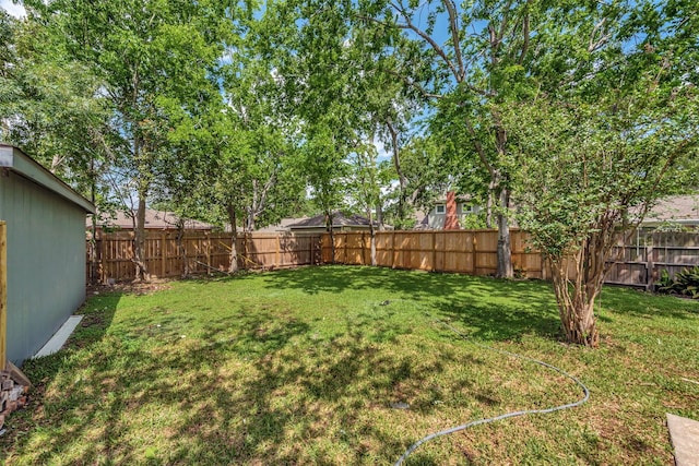 view of yard with a fenced backyard