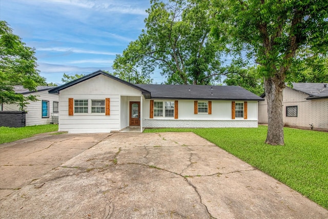 ranch-style home with brick siding and a front lawn