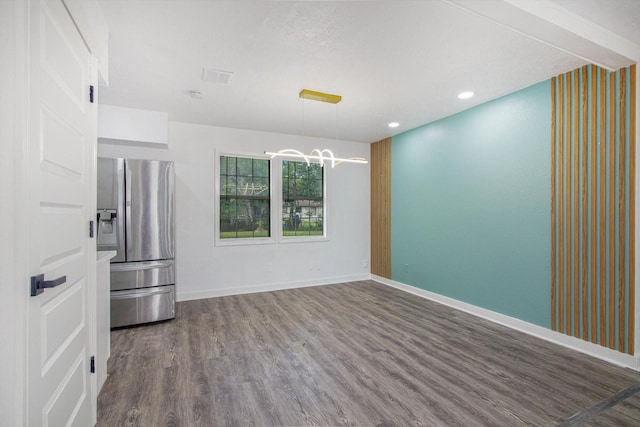 spare room with recessed lighting, baseboards, visible vents, a notable chandelier, and dark wood-type flooring