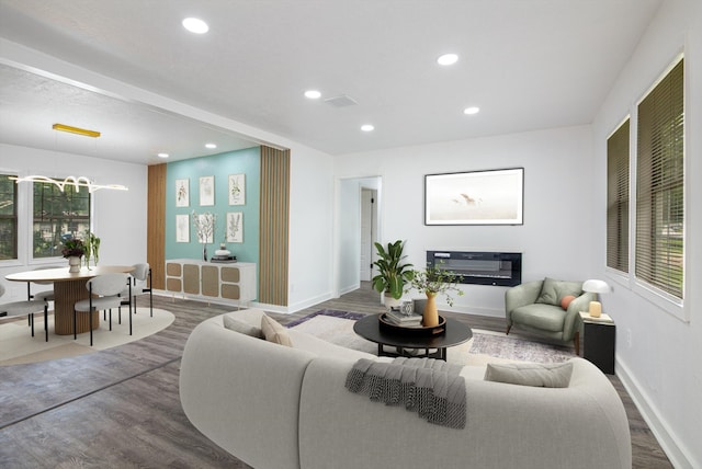 living room with baseboards, visible vents, dark wood-style flooring, and recessed lighting