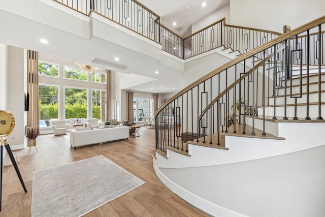 13927 Perthshire Rd, Houston, TX 77079 - stairs with a towering ceiling, baseboards, wood finished floors, and recessed lighting