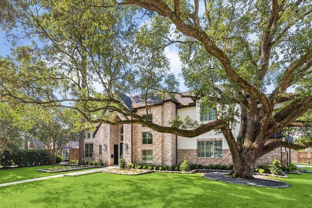 13927 Perthshire Rd, Houston, TX 77079 - view of front of property featuring stucco siding, a front lawn, and stone siding