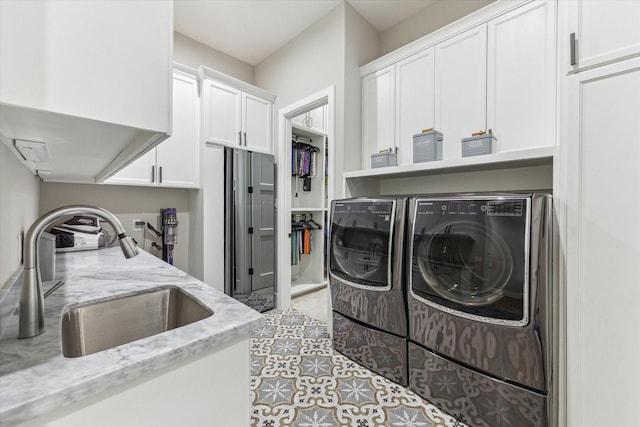 13927 Perthshire Rd, Houston, TX 77079 - laundry room featuring independent washer and dryer and cabinet space