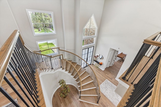13927 Perthshire Rd, Houston, TX 77079 - stairs featuring a high ceiling, wood finished floors, and baseboards