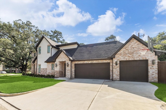 13927 Perthshire Rd, Houston, TX 77079 - french country home with an attached garage, driveway, a front yard, brick siding, and a shingled roof
