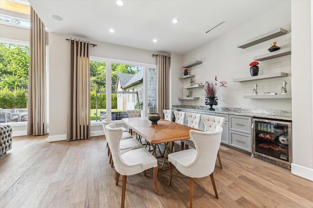 13927 Perthshire Rd, Houston, TX 77079 - dining room featuring beverage cooler, light wood-type flooring, recessed lighting, a bar, and baseboards