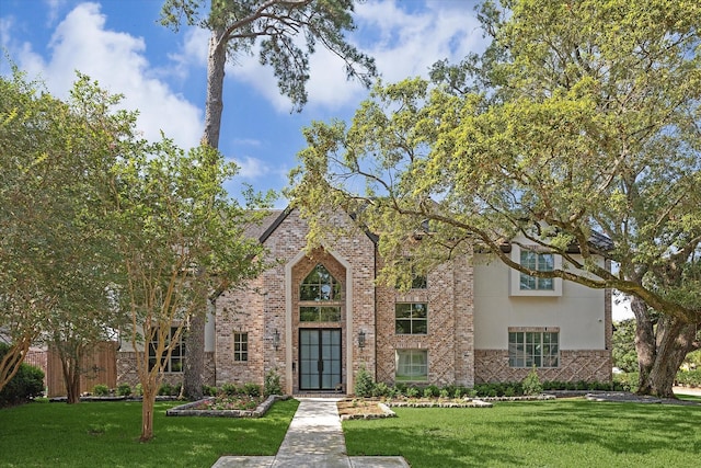 13927 Perthshire Rd, Houston, TX 77079 - view of front of home featuring a front yard, brick siding, and stucco siding