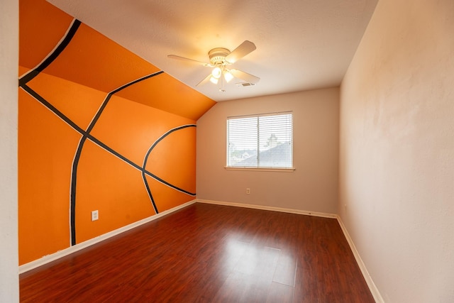 additional living space featuring ceiling fan, visible vents, wood finished floors, baseboards, and lofted ceiling