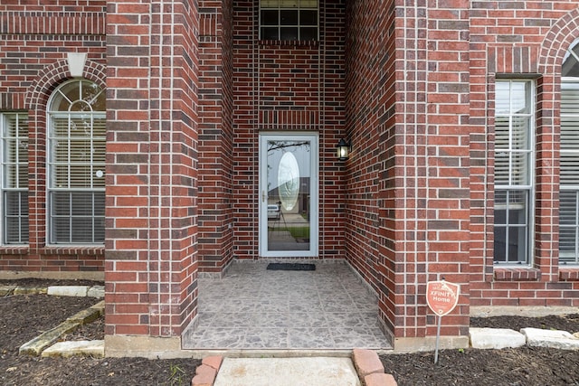 entrance to property with brick siding