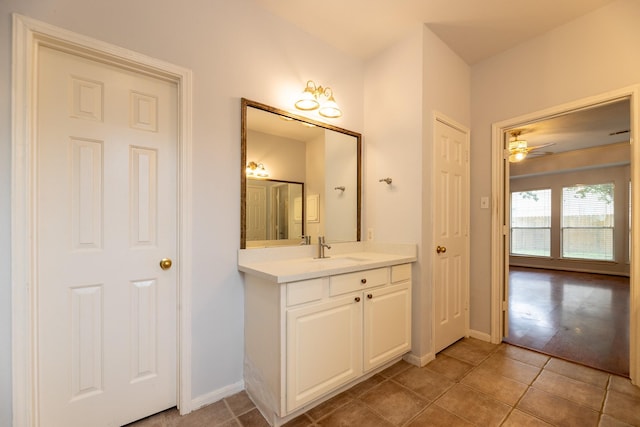 bathroom featuring baseboards, a ceiling fan, vanity, and tile patterned floors