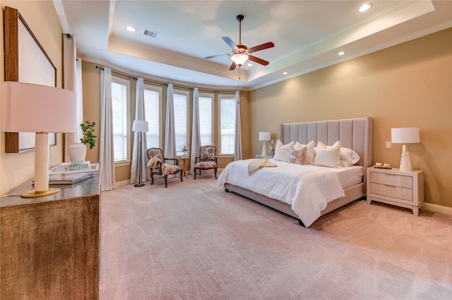bedroom with crown molding, a raised ceiling, light carpet, and visible vents