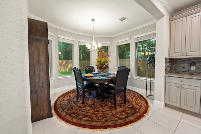 dining room with light tile patterned floors, visible vents, a healthy amount of sunlight, and a chandelier