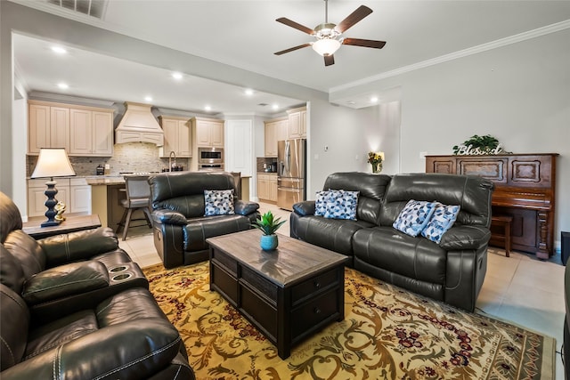 living area with light tile patterned floors, visible vents, recessed lighting, ornamental molding, and a ceiling fan