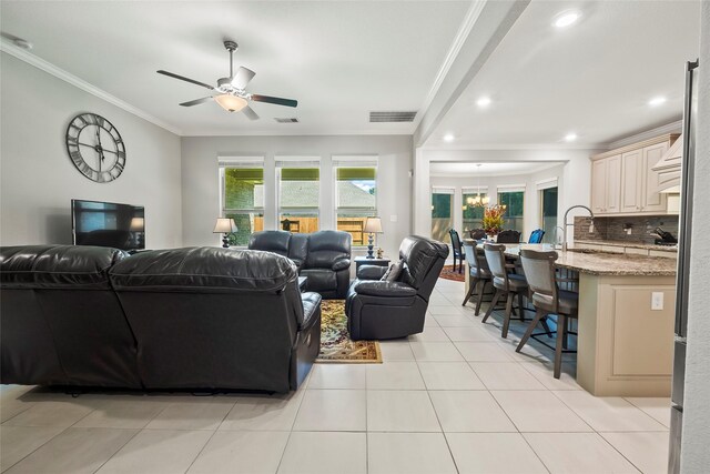living room featuring ornamental molding, ceiling fan, light tile patterned floors, and visible vents