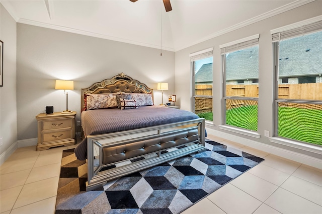 bedroom with lofted ceiling, ornamental molding, tile patterned flooring, and baseboards