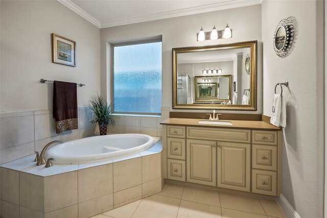 bathroom featuring a bath, tile patterned flooring, crown molding, and vanity