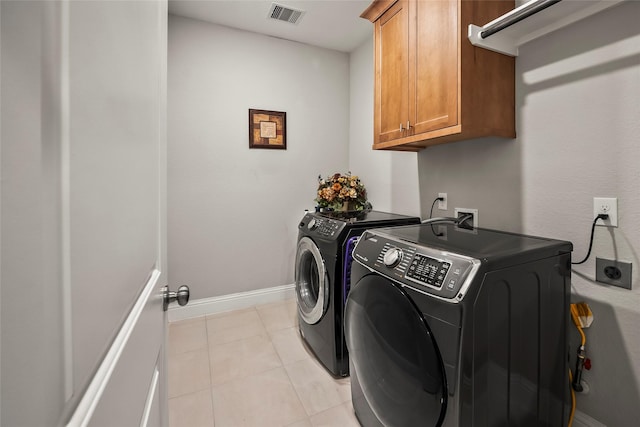 clothes washing area featuring cabinet space, independent washer and dryer, light tile patterned floors, visible vents, and baseboards
