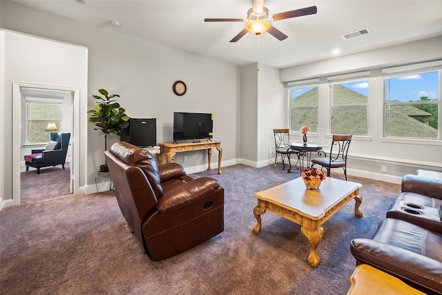 carpeted living room featuring a ceiling fan, visible vents, and baseboards