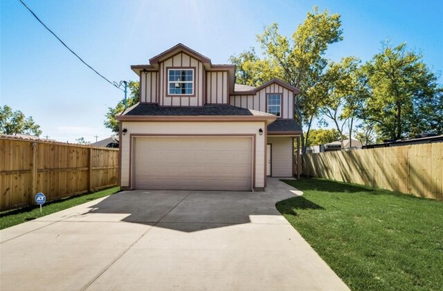view of front of property with board and batten siding, fence, a garage, a front lawn, and concrete driveway