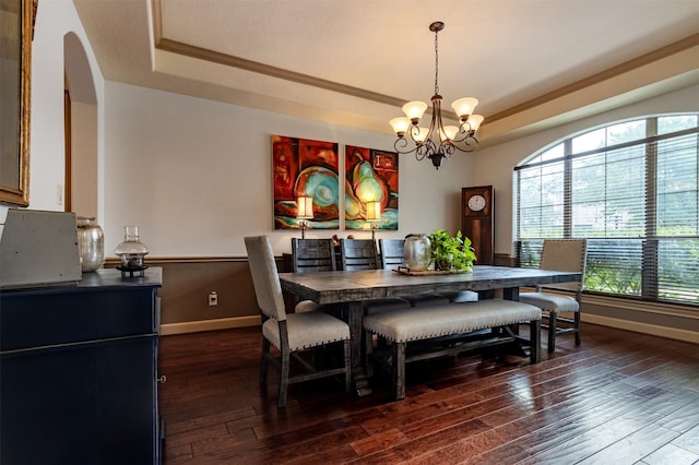 6310 Indiangrass Ct, Katy, TX 77494 - dining area with a tray ceiling, a notable chandelier, baseboards, arched walkways, and dark wood-style floors