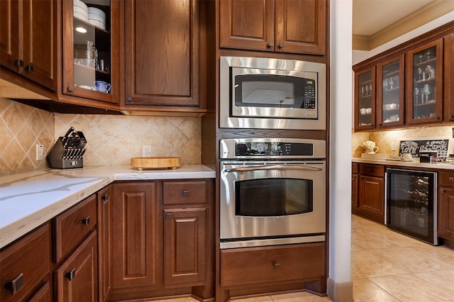 6310 Indiangrass Ct, Katy, TX 77494 - kitchen with light stone countertops, appliances with stainless steel finishes, decorative backsplash, ornamental molding, and wine cooler