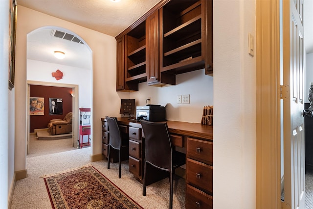 6310 Indiangrass Ct, Katy, TX 77494 - office with built in study area, light carpet, arched walkways, and visible vents