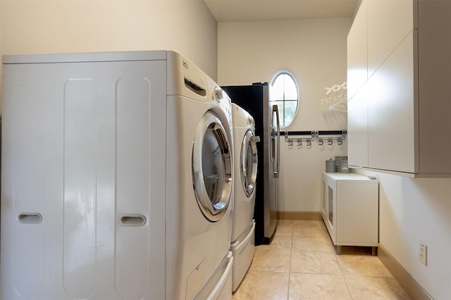 6310 Indiangrass Ct, Katy, TX 77494 - laundry room with washer and clothes dryer, laundry area, baseboards, and light tile patterned floors