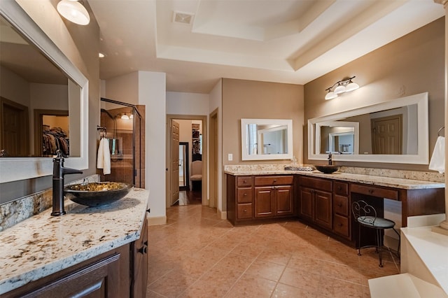 6310 Indiangrass Ct, Katy, TX 77494 - bathroom with a sink, visible vents, tile patterned flooring, a shower stall, and a raised ceiling