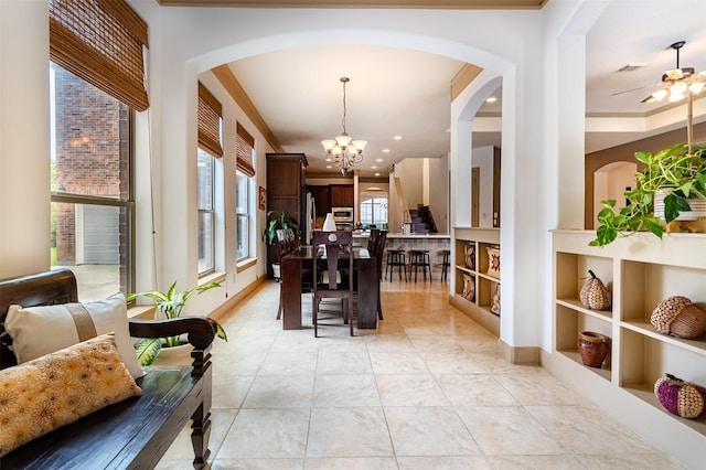 6310 Indiangrass Ct, Katy, TX 77494 - dining space with ceiling fan with notable chandelier, arched walkways, and visible vents