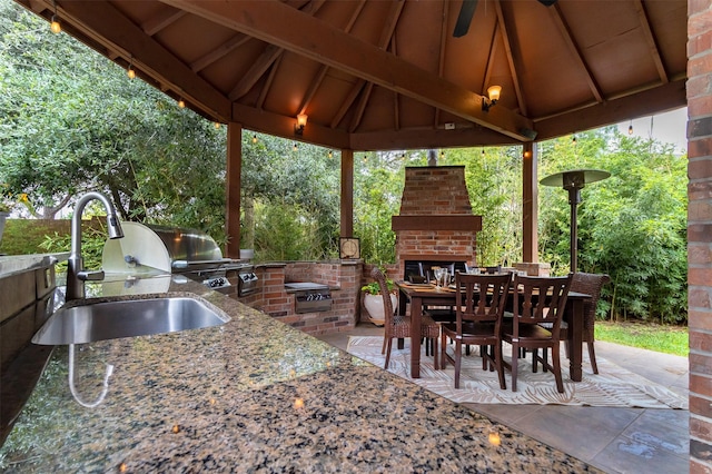 6310 Indiangrass Ct, Katy, TX 77494 - view of patio / terrace with an outdoor brick fireplace, a sink, exterior kitchen, outdoor dining area, and a gazebo