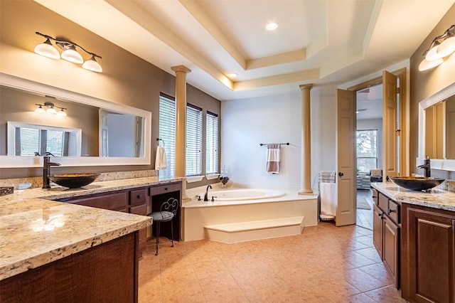 6310 Indiangrass Ct, Katy, TX 77494 - full bath featuring a bath, ornate columns, two vanities, and a sink