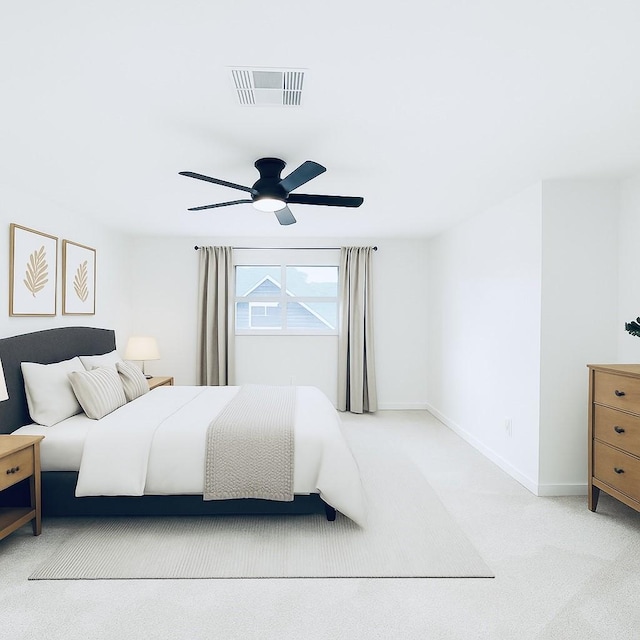 carpeted bedroom featuring visible vents, ceiling fan, and baseboards