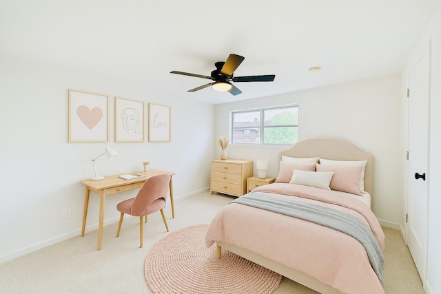 bedroom featuring a ceiling fan, light colored carpet, and baseboards
