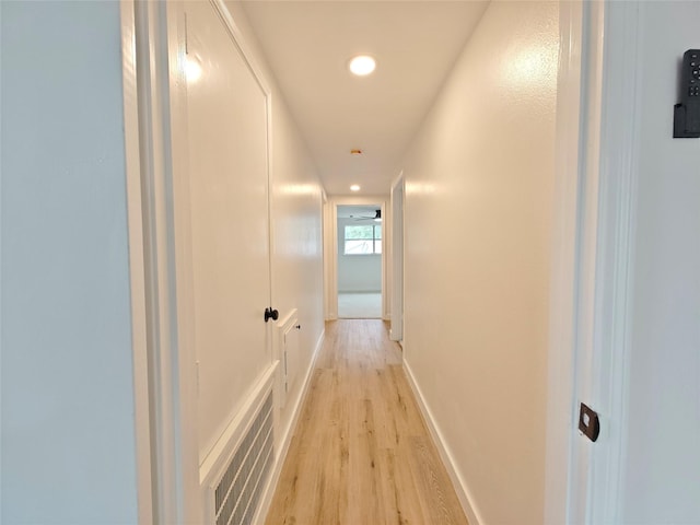 hallway with visible vents, recessed lighting, light wood-style flooring, and baseboards