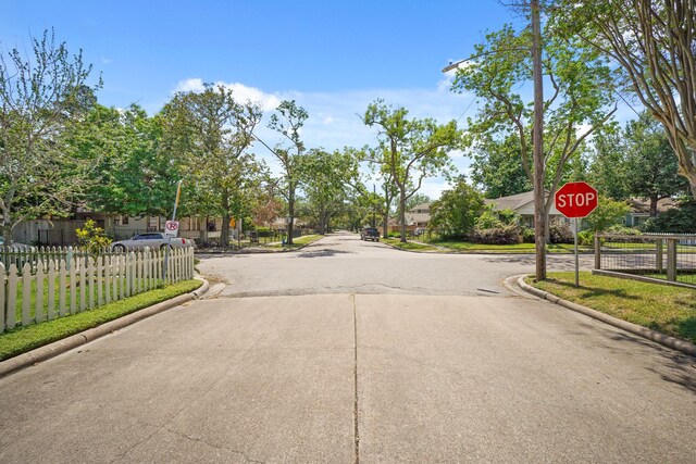 view of street with traffic signs and curbs
