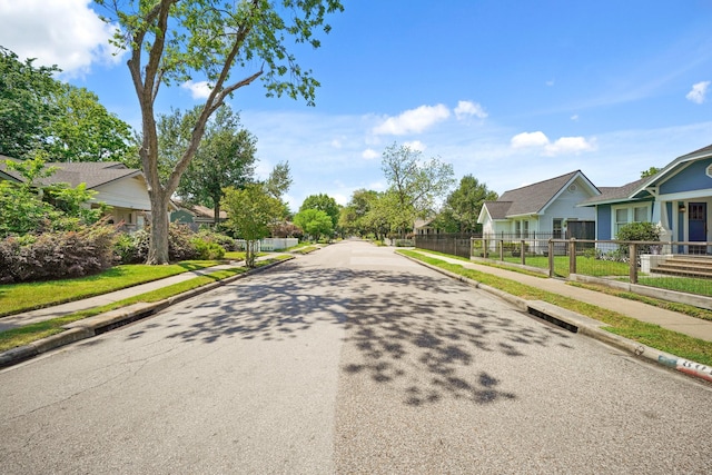 view of road featuring a residential view, sidewalks, and curbs
