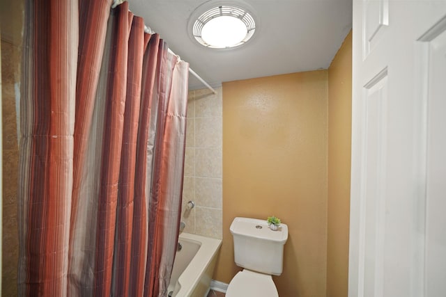 full bathroom featuring toilet and shower / bathtub combination with curtain