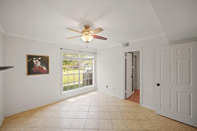 empty room featuring visible vents, a ceiling fan, baseboards, and ornamental molding