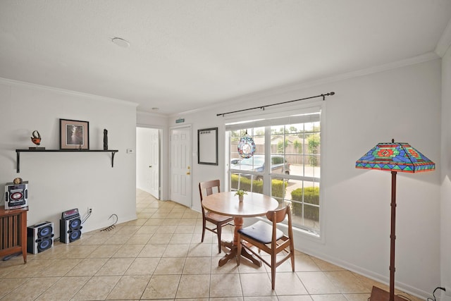 dining area with crown molding and light tile patterned floors