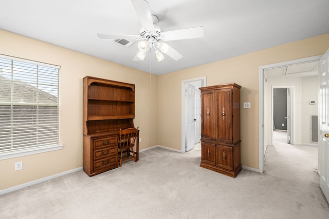 interior space featuring a ceiling fan, attic access, visible vents, light colored carpet, and baseboards
