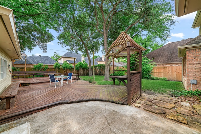 view of patio featuring a fenced backyard, a wooden deck, and outdoor dining area