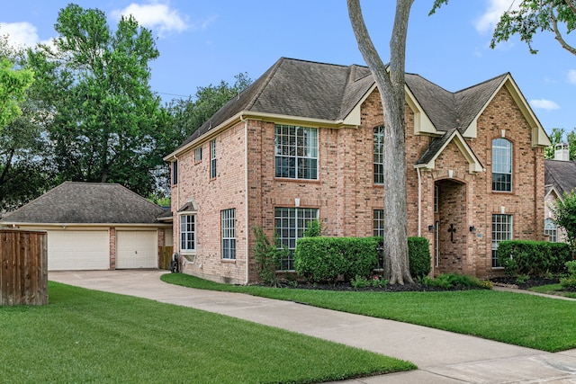view of front facade featuring brick siding and a front yard