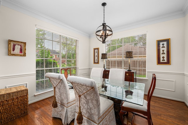 dining area featuring crown molding, baseboards, an inviting chandelier, and wood finished floors