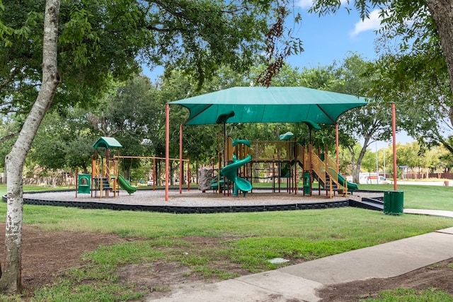 community jungle gym featuring a lawn