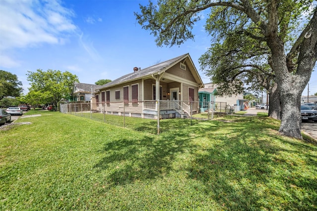 view of front facade featuring fence, a chimney, and a front lawn