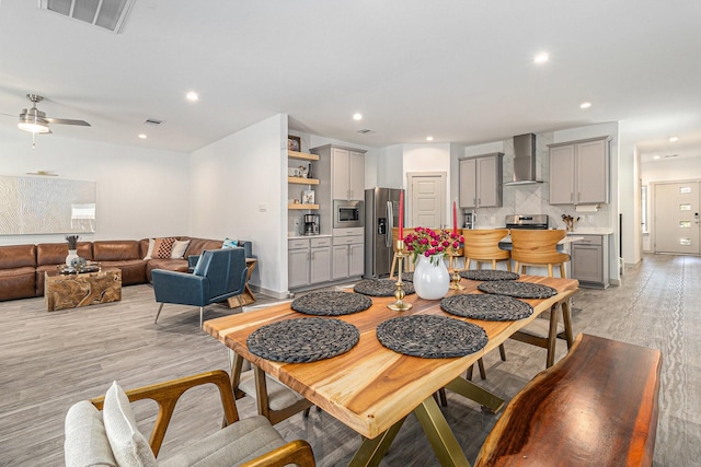 dining area with light wood-style floors, ceiling fan, recessed lighting, and visible vents