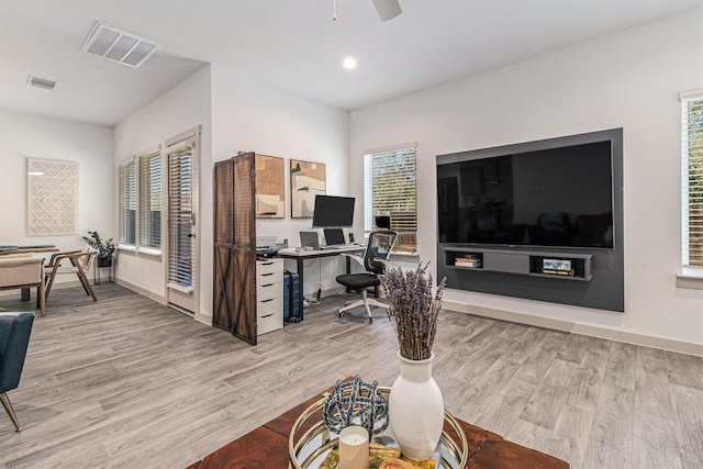 office space with recessed lighting, wood finished floors, and visible vents