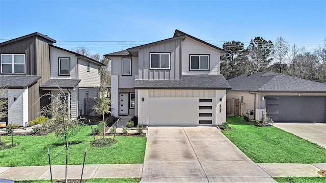 view of front of home with a shingled roof, a front lawn, board and batten siding, and concrete driveway