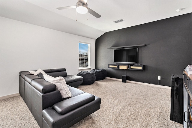 carpeted living room featuring visible vents, baseboards, ceiling fan, and lofted ceiling